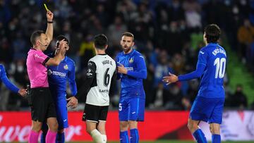 GETAFE, SPAIN - MARCH 12: Referee Guillermo Cuadra Fernandez shows the yellow card to Borja Mayoral of Getafe CF during the LaLiga Santander match between Getafe CF and Valencia CF at Coliseum Alfonso Perez on March 12, 2022 in Getafe, Spain. (Photo by An