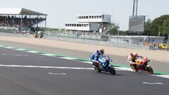 NORTHAMPTON, ENGLAND - AUGUST 25: Alex Rins of Spain and Team Suzuki ECSTAR cuts the finish lane in front of Marc Marquez of Spain and Repsol Honda Team at the end of the MotoGP race during the MotoGp Of Great Britain - Race at Silverstone Circuit on Augu