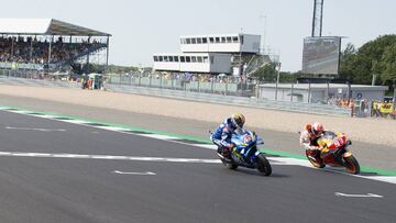 NORTHAMPTON, ENGLAND - AUGUST 25: Alex Rins of Spain and Team Suzuki ECSTAR cuts the finish lane in front of Marc Marquez of Spain and Repsol Honda Team at the end of the MotoGP race during the MotoGp Of Great Britain - Race at Silverstone Circuit on Augu