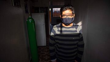 Manuel, 47, a COVID-19 patient poses for a picture at his home in Comas, northern outskirts of Lima, on June 11, 2020. - The Rapid Response Teams of the Ministry of Health are made up of Peruvian and Venezuelan doctors, who visit potential and recovering COVID-19 patients at their homes to take quick tests, make diagnoses and distribute medicines. (Photo by ERNESTO BENAVIDES / AFP)