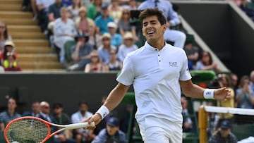 Chile's Cristian Garin celebrates beating Australia's Alex De Minaur (R) during their round of 16 men's singles tennis match on the eighth day of the 2022 Wimbledon Championships at The All England Tennis Club in Wimbledon, southwest London, on July 4, 2022. - RESTRICTED TO EDITORIAL USE (Photo by SEBASTIEN BOZON / AFP) / RESTRICTED TO EDITORIAL USE (Photo by SEBASTIEN BOZON/AFP via Getty Images)