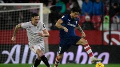 Sevilla's Argentinian forward #05 Lucas Ocampos vies with Athletic Bilbao's Spanish defender #17 Yuri Berchiche during the Spanish league football match between Sevilla FC and Athletic Club Bilbao at the Ramon Sanchez Pizjuan stadium in Seville on January 4, 2024. (Photo by CRISTINA QUICLER / AFP)