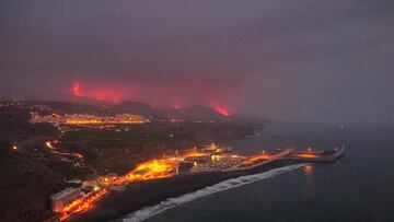 Lava is seen and smoke rises following the eruption of a volcano, in the Port of Tazacorte, on the Canary Island of La Palma, Spain, September 28, 2021. Picture taken with a drone. REUTERS/Nacho Doce