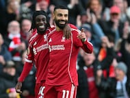 Liverpool's Egyptian striker #11 Mohamed Salah celebrates with Liverpool's Dutch defender #30 Jeremie Frimpong (L) after scoring their second goal during the English Premier League football match between Liverpool and Fulham at Anfield in Liverpool, north west England on April 11, 2026. (Photo by ANDY BUCHANAN / AFP) / RESTRICTED TO EDITORIAL USE. No use with unauthorized audio, video, data, fixture lists, club/league logos or 'live' services. Online in-match use limited to 120 images. An additional 40 images may be used in extra time. No video emulation. Social media in-match use limited to 120 images. An additional 40 images may be used in extra time. No use in betting publications, games or single club/league/player publications. /