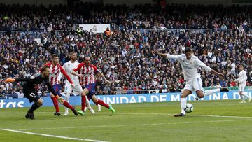 Jan Oblak makes a key save on Raphaël Varane.