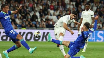 Real Madrid's Spanish midfielder Marco Asensio vies with Getafe's Spanish midfielder Jaime Seoane (R) during the Spanish league football match between Real Madrid CF and Getafe CF at the Santiago Bernabeu stadium in Madrid on May 13, 2023. (Photo by Thomas COEX / AFP)