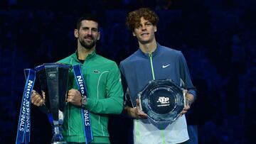 Italy's Jannik Sinner and Serbia's Novak Djokovic pose with their trophy after the final match at the ATP Finals tennis tournament in Turin on November 19, 2023. Djokovic won 6-3, 6-3. (Photo by Tiziana FABI / AFP)