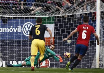 Oblak (centre) saves Torres' penalty.