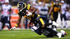 PITTSBURGH, PA - DECEMBER 16: Antonio Brown #84 of the Pittsburgh Steelers is wrapped up for a tackle by Stephon Gilmore #24 of the New England Patriots in the first quarter during the game at Heinz Field on December 16, 2018 in Pittsburgh, Pennsylvania. 