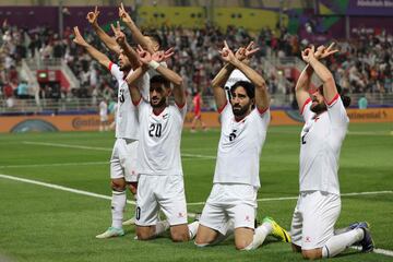 Palestine's players celebrate their second goal during the Qatar 2023 AFC Asian Cup Group C football match between Hong Kong and Palestine at the Abdullah bin Khalifa Stadium in Doha on January 23, 2024. (Photo by Giuseppe CACACE / AFP)