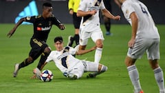 Latif Blessing #7 of Los Angeles FC dribbles the ball in front of Cristian Pavon #10, Giancarlo Gonzalez #21 and Dave Romney #4 of Los Angeles Galaxy during the second half in a 5-3 LAFC win in the Western Conference Semifinals