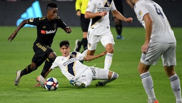 Latif Blessing #7 of Los Angeles FC dribbles the ball in front of Cristian Pavon #10, Giancarlo Gonzalez #21 and Dave Romney #4 of Los Angeles Galaxy during the second half in a 5-3 LAFC win in the Western Conference Semifinals