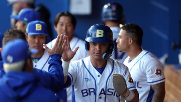 TUCSON, ARIZONA - MARCH 06: Gabriel Gomes #10 of Brazil high fives teammates in the dugout after scoring a run during the first inning of game seven of the World Baseball Classic Qualifiers against Germany at Kino Veterans Memorial Stadium on March 06, 2025 in Tucson, Arizona. Chris Coduto/Getty Images/AFP (Photo by Chris Coduto / GETTY IMAGES NORTH AMERICA / Getty Images via AFP)