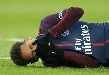 Neymar lies on the pitch after sustaining injury.