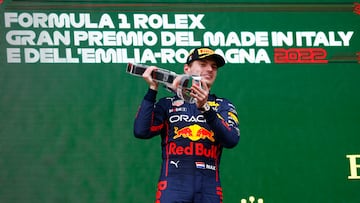 Red Bull's Max Verstappen celebrates on the podium with the trophy after winning at Imola.