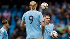 MANCHESTER, ENGLAND - OCTOBER 02: Phil Foden of Manchester City hands a match ball to team mate Erling Haaland after both scoring a hat trick during the Premier League match between Manchester City and Manchester United at Etihad Stadium on October 02, 2022 in Manchester, England. (Photo by Lynne Cameron - Manchester City/Manchester City FC via Getty Images)