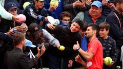 Novak Djokovic signs autographs after beating Diego Schwartzman on Day 8 of The 2022 French Open at Roland Garros.