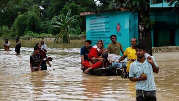 People move a cart with a woman and a child through a flooded street, amid severe flooding in the Fazilpur area of Feni, Bangladesh, August 26, 2024. REUTERS/Mohammad Ponir Hossain