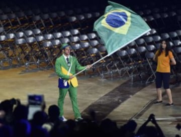 The Brazil flag bearer enters the stadium during the opening ceremony for the 2015 Pan American Games at the Rogers Centre in Toronto, Ontario, on July 10, 2015. AFP PHOTO/OMAR TORRES