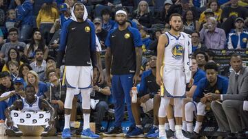 September 29, 2018; Oakland, CA, USA; Golden State Warriors forward Kevin Durant (35), center DeMarcus Cousins (0), and guard Stephen Curry (30) watch from the bench during the fourth quarter against the Golden State Warriors at Oracle Arena. The Timberwolves defeated the Warriors 114-110. Mandatory Credit: Kyle Terada-USA TODAY Sports