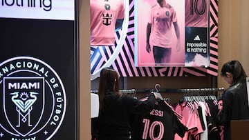 A shopper looks at jerseys on sale of Inter Miami's Argentine player Lionel Messi in a store in Hong Kong on January 30, 2024, ahead of a friendly exhibition match between Hong Kong Team and Inter Miami on February 4. (Photo by Peter PARKS / AFP)