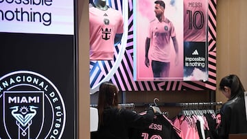 A shopper looks at jerseys on sale of Inter Miami's Argentine player Lionel Messi in a store in Hong Kong on January 30, 2024, ahead of a friendly exhibition match between Hong Kong Team and Inter Miami on February 4. (Photo by Peter PARKS / AFP)