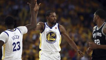 Golden State Warriors' Kevin Durant (35) celebrates a score with Draymond Green, left, as San Antonio Spurs' Rudy Gay (22) watches during the second half in Game 1 of a first-round NBA basketball playoff series Saturday, April 14, 2018, in Oakla