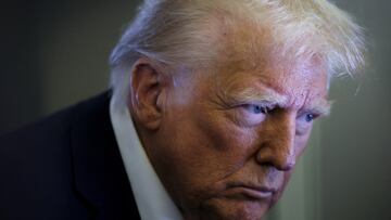 U.S. President Donald Trump looks on as reporters ask questions aboard Air Force One during a flight from Las Vegas, Nevada, to Miami, Florida, U.S., January 25, 2025. REUTERS/Leah Millis