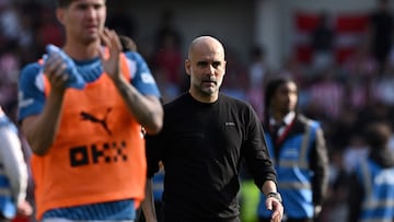 Manchester City's Spanish manager Pep Guardiola walks off the pitch at the end of the English Premier League football match between Brentford and Manchester City at Gtech Community Stadium in London on May 28, 2023. (Photo by Ben Stansall / AFP) / RESTRICTED TO EDITORIAL USE. No use with unauthorized audio, video, data, fixture lists, club/league logos or 'live' services. Online in-match use limited to 120 images. An additional 40 images may be used in extra time. No video emulation. Social media in-match use limited to 120 images. An additional 40 images may be used in extra time. No use in betting publications, games or single club/league/player publications. /