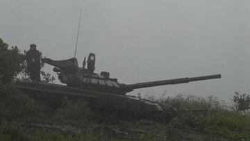 A Russian serviceman stands atop a tank as he takes part in the 'Vostok-2022' military exercises at the Sergeevskyi training ground outside the city of Ussuriysk on the Russian Far East on September 6, 2022. - The Vostok 2022 military exercises, involving several Kremlin-friendly countries including China, takes place from September 1-7 across several training grounds in Russia's Far East and in the waters off it. Over 50,000 soldiers and more than 5,000 units of military equipment, including 140 aircraft and 60 ships, are involved in the drills. (Photo by Kirill KUDRYAVTSEV / AFP) (Photo by KIRILL KUDRYAVTSEV/AFP via Getty Images)
