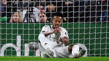 Real Madrid's Brazilian defender #03 Eder Militao puts his shoe back on during the Spanish league football match between Athletic Club Bilbao and Real Madrid CF at the San Mames stadium in Bilbao on December 3, 2025. (Photo by ANDER GILLENEA / AFP)