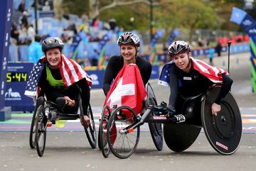 La corredora suiza Manuela Schar celebra la victoria de la carrera de Profesionales en Silla de Ruedas junto a las norteamericanas Tatyana McFadden y Amanda McGrory.