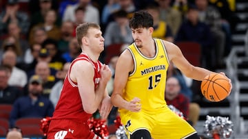 Mar 14, 2026; Chicago, IL, USA; Wisconsin Badgers forward Aleksas Bieliauskas (32) defends against Michigan Wolverines center Aday Mara (15) during the first half at United Center. Mandatory Credit: Kamil Krzaczynski-Imagn Images
