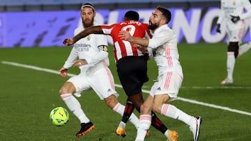 GRAF6118. MADRID, 15/12/2020.- El delantero del Athletic del Bilbao, I&ntilde;aki Williams (c), intenta llevarse el bal&oacute;n ante la entrada del defensa del Real Madrid, Dani Carvajal (d), jugada en la que el equipo vasco ha reclamado penalti sobre el