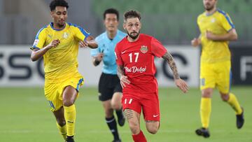 Shabab's midfielder Federico Cartabia (R) is marked by Gharafa's defender Homam Ahmed (L) during the AFC Champions League group C match between UAE's Shabab Al-Ahli and Qatar's Al-Gharafa on April 18, 2022, at the Prince Abdullah al-Faisal stadium in the Saudi city of Jeddah. (Photo by AFP)