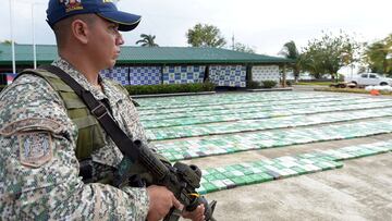 FILE PHOTO: A member of the Colombian navy stands guard along with 5.2 tons of cocaine that were seized in Turbo, Colombia March 6, 2018. Colombian Defense Ministry/Handout via REUTERS     ATTENTION EDITORS -  THIS IMAGE HAS BEEN SUPPLIED BY A THIRD PARTY/File Photo
