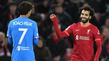 Liverpool's Egyptian midfielder Mohamed Salah (R) laughs with Atletico Madrid's Portuguese midfielder Joao Felix during the UEFA Champions League group B football match between Liverpool and Atletico Madrid at Anfield in Liverpool, north west En