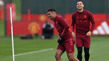 Manchester United's Portuguese defender #20 Diogo Dalot (R) and Manchester United's Brazilian midfielder #18 Casemiro react during a training session at the Carrington Training Complex in Manchester, north-west England on October 23, 2023 ahead of their UEFA Champions League Group A football match against FC Copenhagen. (Photo by Paul ELLIS / AFP)