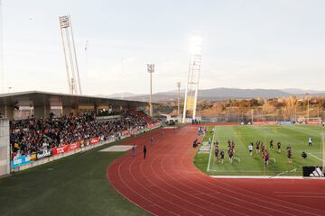 Aficionados en las gradas del campo principal de La Ciudad del Fútbol en la sesión vespertina