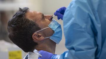 IRUN, SPAIN - SEPTEMBER 02: A health worker does a PCR test on a patient at Ficoba exhibition site, a place enabled for massive tests of Coronavirus on September 02, 2020 in Irun, Spain. Some infections were detected at the Gaztelumendi bar in the town centre and all customers who were at the bar between the 24th and 28th of August have been asked to have a PCR test. On the first day, more than 500 PCR tests have been carried out to detect possible infections and to limit outbreaks. (Photo by Gari Garaialde/Getty Images)