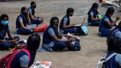 Students sit with course materials maintaining social distancing to collect text books before attending a tele-learning class at their home, an initiative set up by the Department of School Education to allow students from class 2 to 10 to continue with t