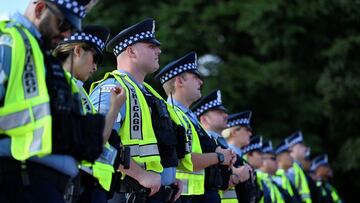 Policemen stand guard during a demonstration calling for justice for Sonya Massey, a 36-year-old Black woman shot and killed by an Illinois sheriff's deputy during a call for help at her home, in Chicago, Illinois, U.S., August 17, 2024. REUTERS/Vincent Alban