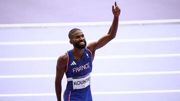 France's Muhammad Abdallah Kounta celebrate after competing in the men's 4x400m relay heat of the athletics event at the Paris 2024 Olympic Games at Stade de France in Saint-Denis, north of Paris, on August 9, 2024. (Photo by Anne-Christine POUJOULAT / AFP)