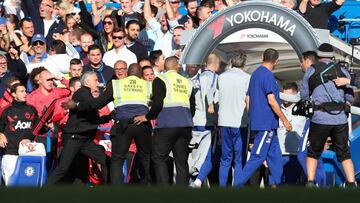 LONDON, ENGLAND - OCTOBER 20: Stewards hold back Jose Mourinho, Manager of Manchester United as he clashes with the Chelsea backroom staff during the Premier League match between Chelsea FC and Manchester United at Stamford Bridge on October 20, 2018 in