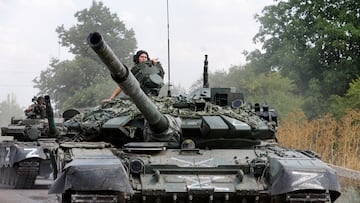 FILE PHOTO: Service members of pro-Russian troops drive tanks in the course of Ukraine-Russia conflict near the settlement of Olenivka in the Donetsk region, Ukraine July 29, 2022. REUTERS/Alexander Ermochenko/File Photo