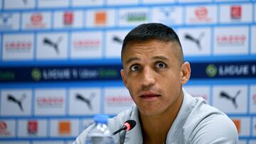 Marseille's Chilean forward Alexis Sanchez looks on as he attends a press conference after the Olympique de Marseille (OM) announced his signing, at Stade Velodrome in Marseille, southern France, on August 10, 2022. - Marseille has announced on August 10, 2022 the signing of Chilean forward Alexis Sanchez, who has played for Barcelona, Arsenal and Inter Milan, and who will bring his talent, goalscoring ability and experience of the highest level to the attack. (Photo by CHRISTOPHE SIMON / AFP)