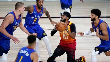 Aug 21, 2020; Lake Buena Vista, Florida, USA; Utah Jazz's Mike Conley (10) drives as Denver Nuggets' Monte Morris (11), Nikola Jokic (15), Michael Porter Jr. (1) and Jamal Murray, right, defend during the first half of an NBA basketball first ro