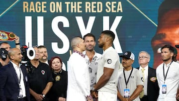 Oleksandr Usyk (left) and Anthony Joshua (right) with boxing promotor Eddie Hearn during the weigh in at the King Abdullah Sport City Stadium in Jeddah, Saudi Arabia.