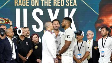 Oleksandr Usyk (left) and Anthony Joshua (right) with boxing promotor Eddie Hearn during the weigh in at the King Abdullah Sport City Stadium in Jeddah, Saudi Arabia.