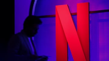 FILE PHOTO: A man stands next to a logo of Netflix during an event in Mumbai, India, February 29, 2024. REUTERS/Francis Mascarenhas/File Photo